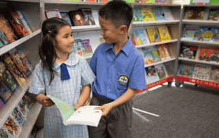 A photo showing two students from St Anthony's Catholic Primary School Marsfield learning in the library